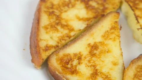 Served fried tasty toasts bread slices on plate on kitchen at home. Stock Footage 313134993