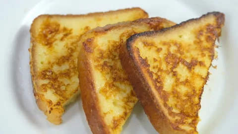 Served fried three tasty toasts bread slices on plate on kitchen at home. Stock Footage 313135134
