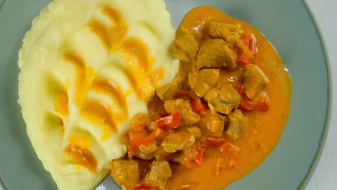 Served goulash with mashed potatoes creamy sauce on plate on kitchen at home. Stock Footage 312403153
