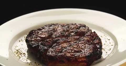 Served grilled meat steak on plate 4k rotation looped video. Fried beef spice Stock Footage 70006029