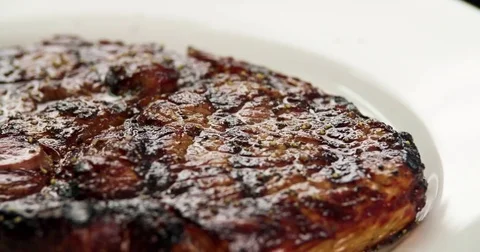 Served grilled meat steak on plate 4k rotation close-up video. Fried beef Stock Footage 70006221