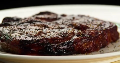 Served grilled meat steak on plate 4k rotation looped video. Fried beef barbecue Stock Footage 70006519