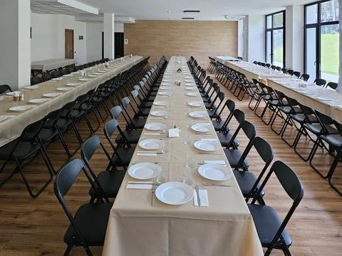 Served long table in a large dining room. Cutlery on the table. Wedding tab.. Stock Photos