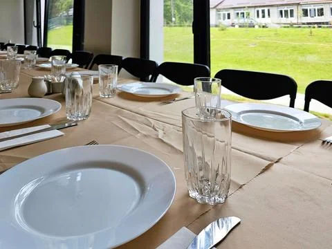 Served long table in a large dining room. Cutlery on the table. Wedding tab.. 写真素材