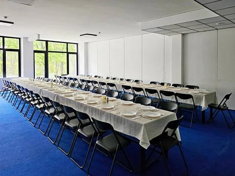 Served long table in a large dining room. Cutlery on the table. Wedding tab.. Stock Photos