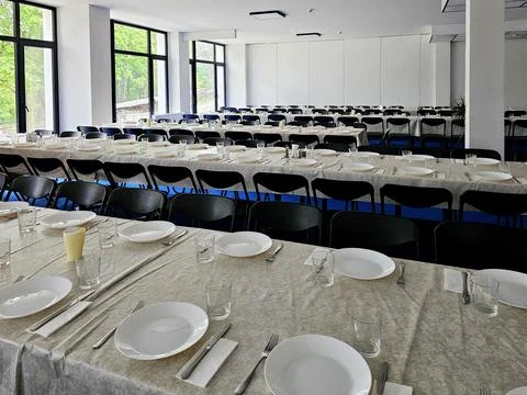Served long table in a large dining room. Cutlery on the table. Wedding tab.. Stock Photos