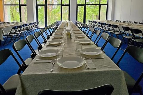 Served long table in a large dining room. Cutlery on the table. Wedding tab.. Stock Photos