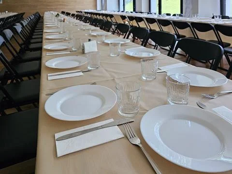 Served long table in a large dining room. Cutlery on the table. Wedding tab.. Stock Photos