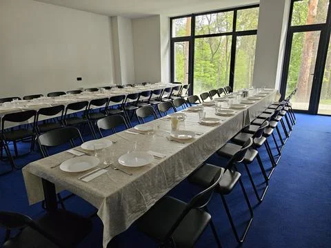 Served long table in a large dining room. Cutlery on the table. Wedding tab.. Stock Photos