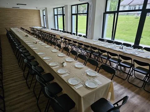 Served long table in a large dining room. Cutlery on the table. Wedding tab.. Stock Photos