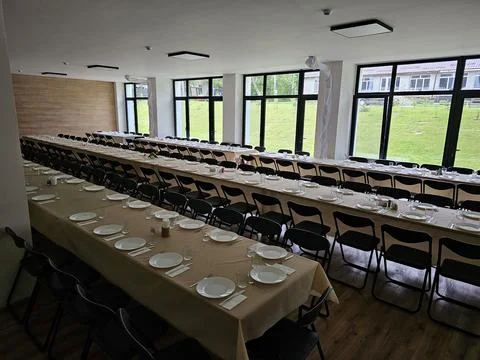 Served long table in a large dining room. Cutlery on the table. Wedding tab.. Stock Photos
