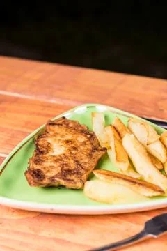 Served lunch with fried chicken breasts in eggs with french fries Stock Photos