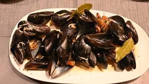 Served Mediterranean mussel. Shellfish on a table in restaurant. Stock Footage 297008058