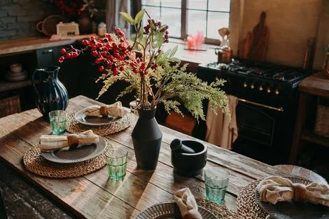 Served nicely decorated dining table with plates napkins vase. Kitchen Stock Photos