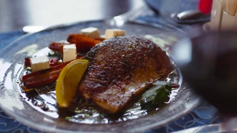 Served roasted fish with lemon and cheese. Being gourmet. Restaurant food Stock Footage 74624501