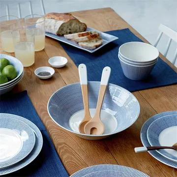 Served table with ceramic plates and bowl and wooden design spoons Stock Photos