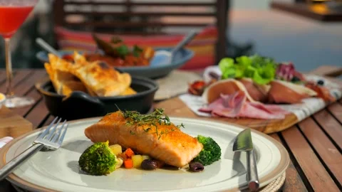 Served table with dinner food at outdoor restaurant in luxury hotel. Fine dining Stock Footage 201376904