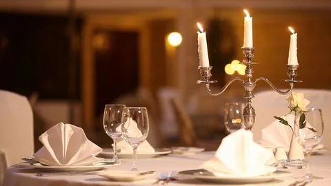 Served table with dishes and candles in a restaurant Stock Footage