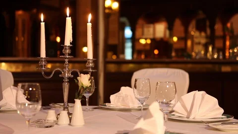 Served table with dishes and candles in a restaurant Stock Footage 121274142
