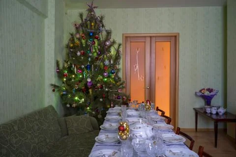 Served table with festive tableware near beautiful decorated Christmas tree i Stock Photos