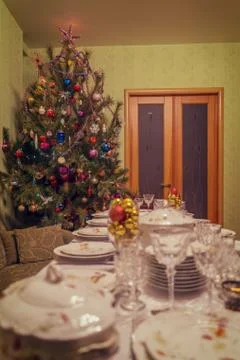 Served table with festive tableware near beautiful decorated Christmas tree i Stock Photos