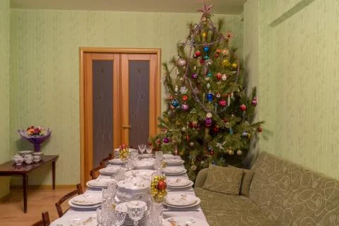 Served table with festive tableware near beautiful decorated Christmas tree i Stock Photos