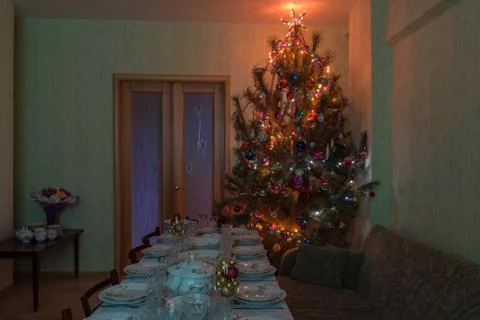 Served table with festive tableware near beautiful decorated Christmas tree i Stock Photos