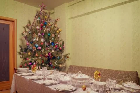 Served table with festive tableware near beautiful decorated Christmas tree i Stock Photos