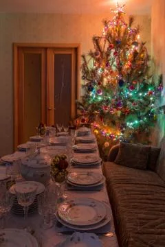 Served table with festive tableware near beautiful decorated Christmas tree i Stock Photos
