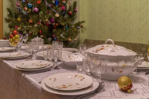 Served table with festive tableware near beautiful decorated Christmas tree i Stock Photos