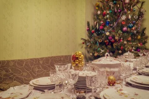 Served table with festive tableware near beautiful decorated Christmas tree i Stock Photos