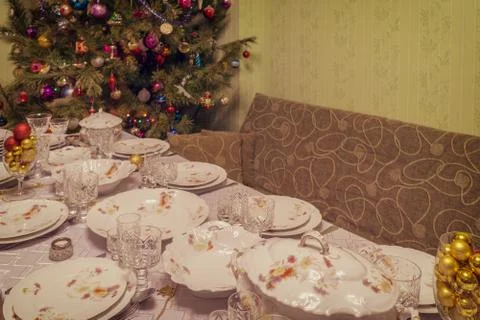 Served table with festive tableware near beautiful decorated Christmas tree i Stock Photos