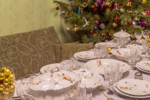 Served table with festive tableware near beautiful decorated Christmas tree i Stock Photos