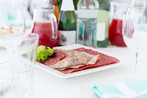 Served table layout with meat snack plate Stock Photos