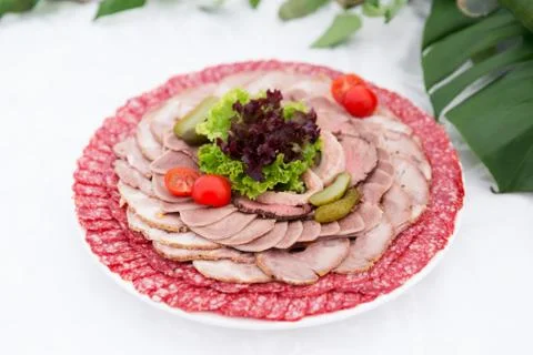 Served table layout with meat snack plate Stock Photos