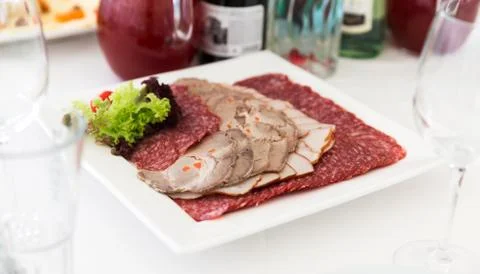 Served table layout with meat snack plate Stock Photos