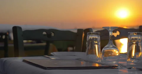 Served table in outdoor restaurant at sunset Stock Footage 64709220