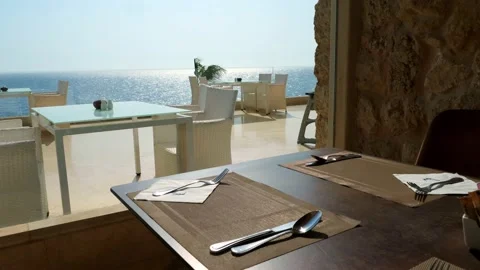 Served table in the restaurant by a large panoramic window overlooking the sea. Stock Footage 136840011