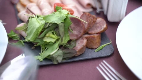 Served table with sausage and cold cuts. Slow motion Видео 248389887