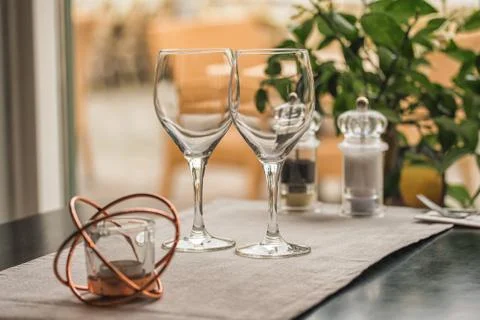 Served table set at summer terrace cafe with two glasses of wine Stock Photos