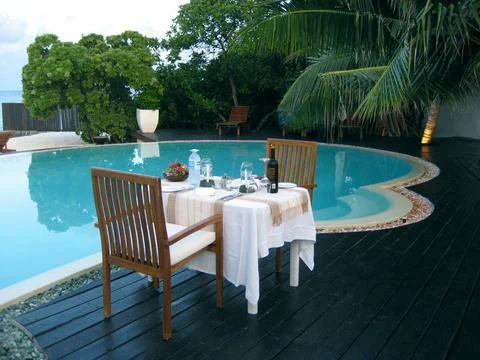 Served Table for Two by the Pool Maldives Stock Photos