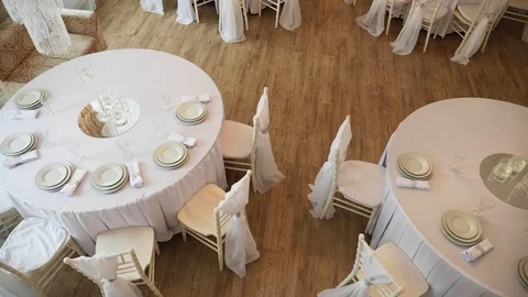A served table with a white cloth on which there are plates and napkins Stock Footage 97717757