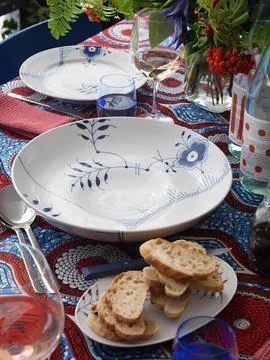 Served table with white empty plates and wine glasses Stock Photos