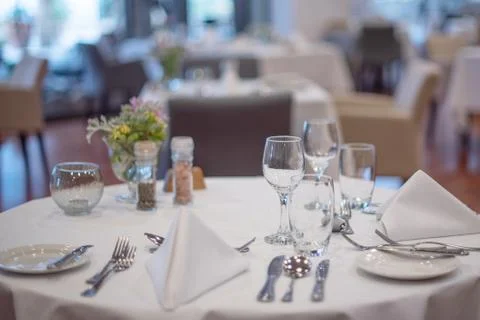 Served table with a white tablecloth Stock Photos