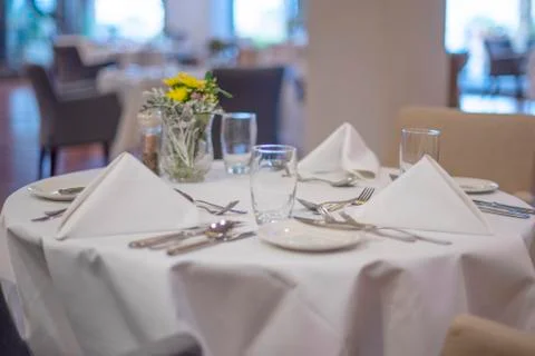 Served table with a white tablecloth Stock Photos