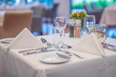 Served table with a white tablecloth Stock Photos