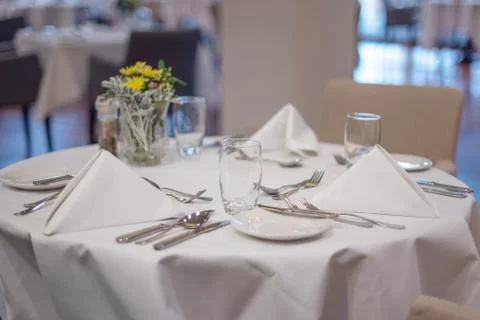 Served table with a white tablecloth Stock Photos
