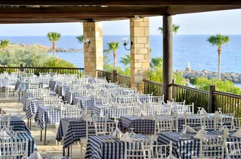 Served tables of the restaurant on the beach Stock Photos