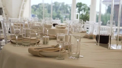 Served tables with white tablecloths, with glass glasses, plates Stock Footage 172192572