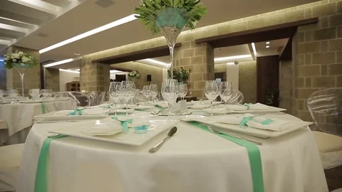 Served tables with wine glasses, white tablecloth and wooden chairs of wedding Stock Footage 71996155